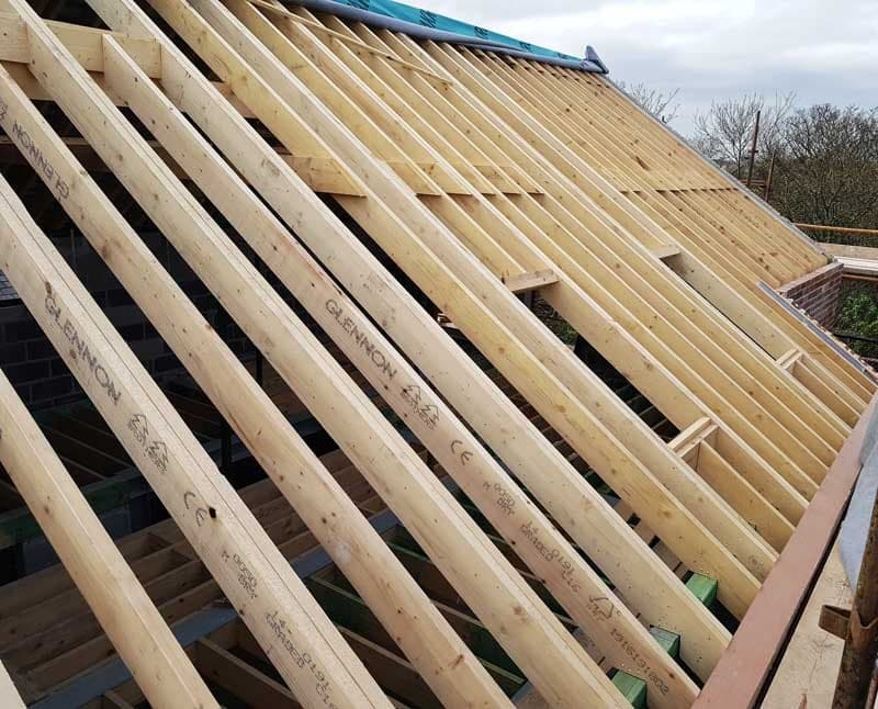 Timber rafters being fixed during roof construction